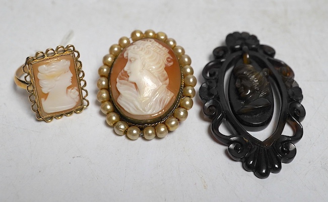 A yellow metal shell cameo ring, a brooch and a pendant. Condition - fair